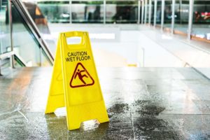 commercial cleaning wet floor sign near an escalator